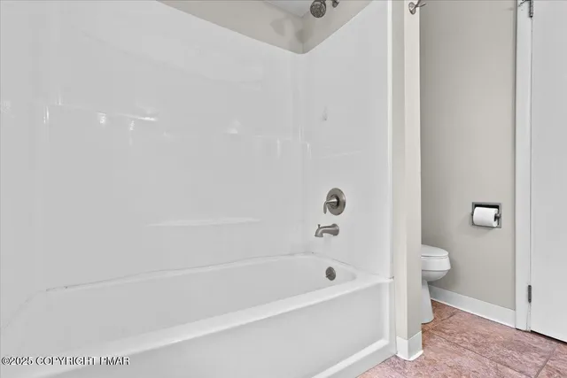 a bathroom with a bathtub and a toilet