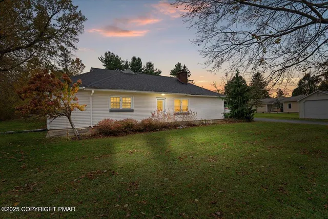 a front view of house with yard and green space