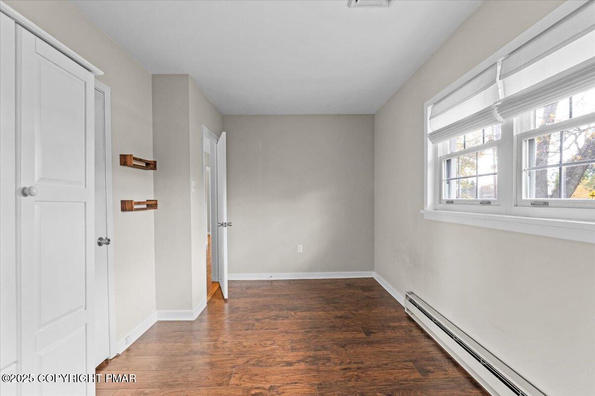 1215 Country Club Road Clarks Summit, PA 18411 - Photo 29 of 50 a view of an empty room with wooden floor and a window