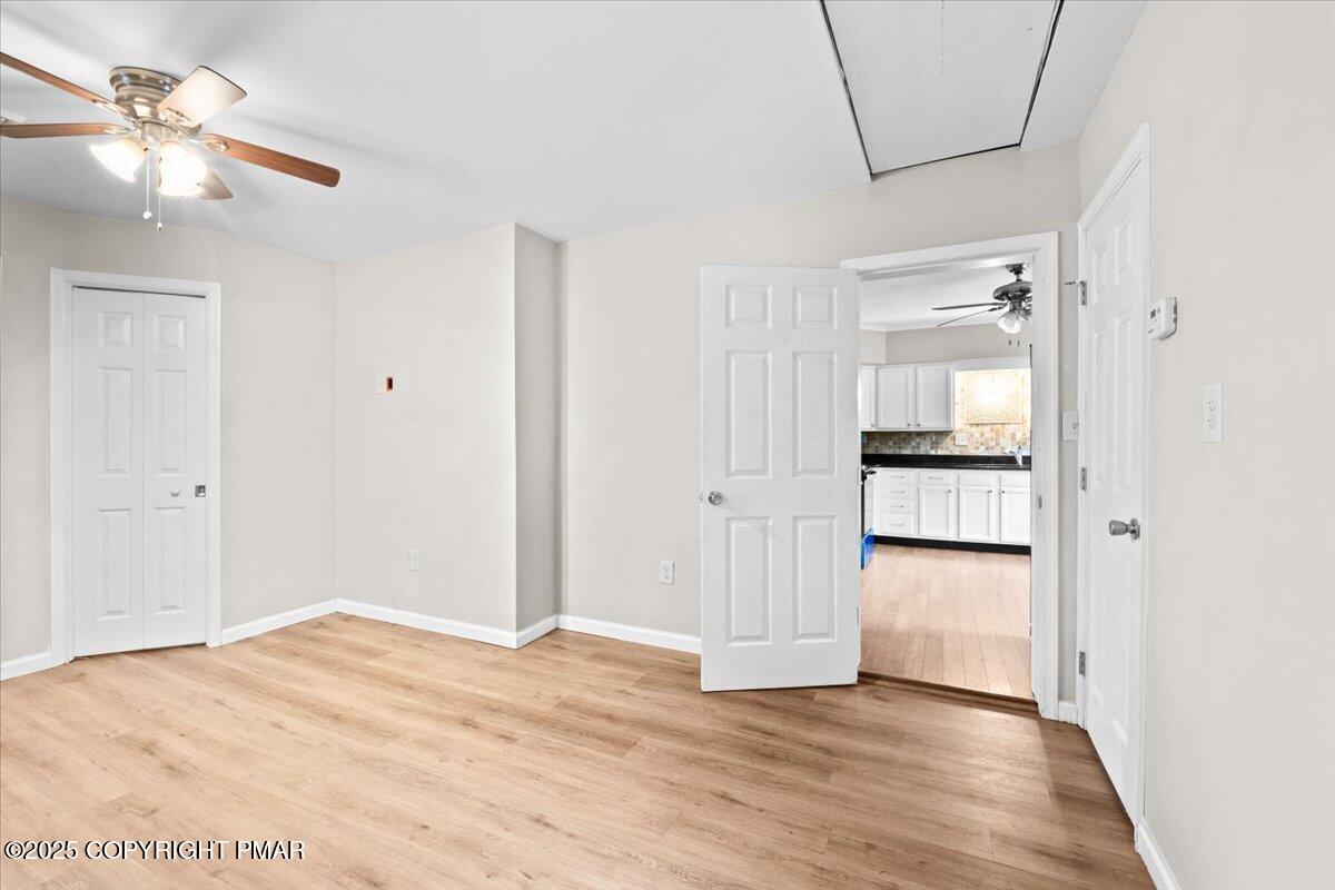 1215 Country Club Road Clarks Summit, PA 18411 - Photo 31 of 50 a view of empty room with wooden floor and kitchen view