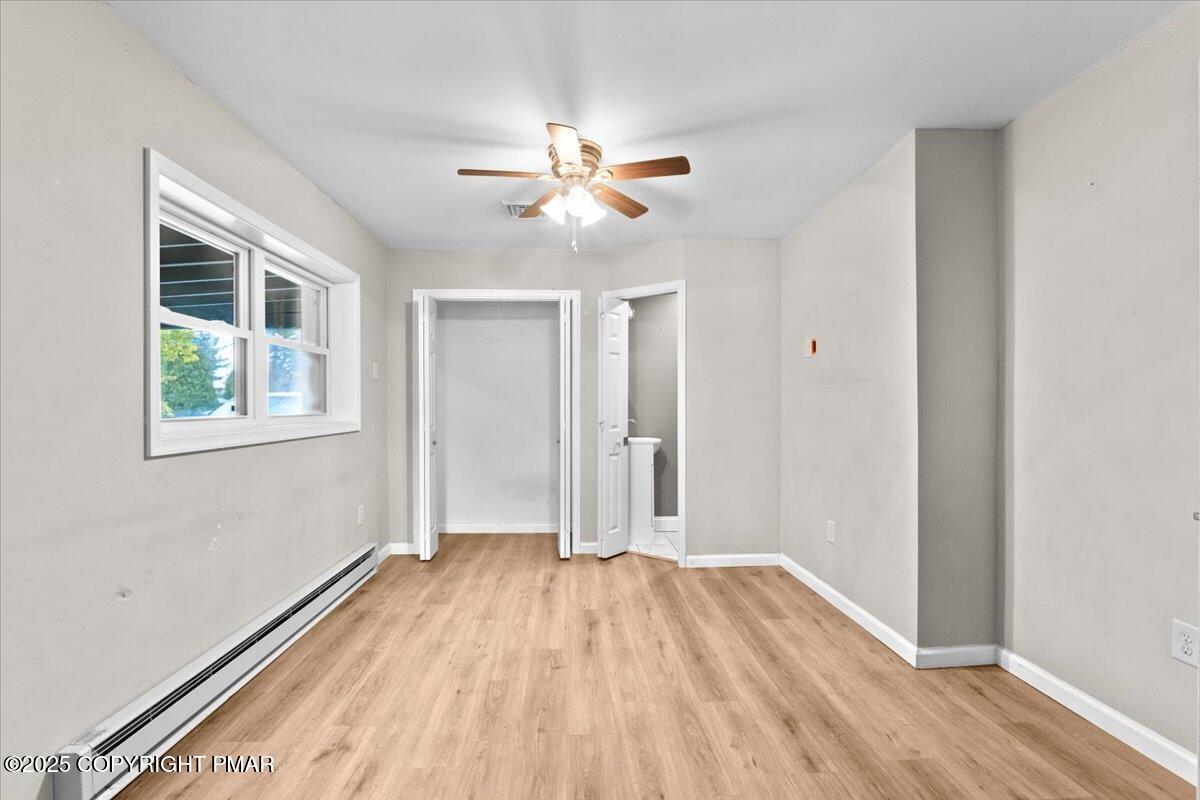 1215 Country Club Road Clarks Summit, PA 18411 - Photo 34 of 50 a view of empty room with wooden floor and fan