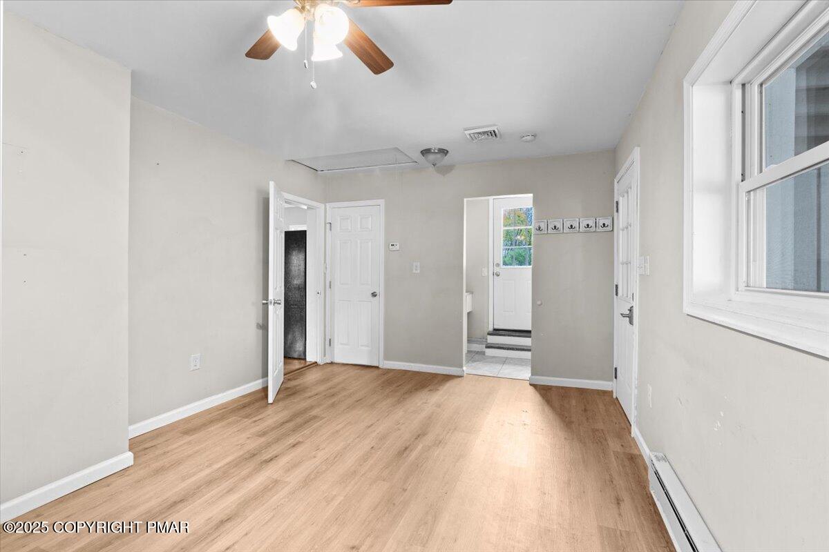 1215 Country Club Road Clarks Summit, PA 18411 - Photo 37 of 50 a view of a room with wooden floor and a ceiling fan