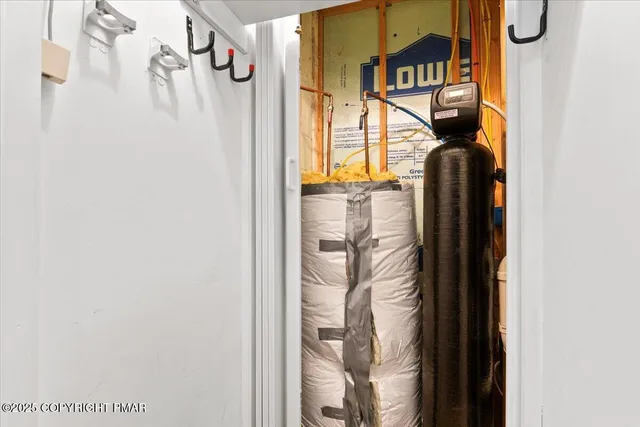 a front view of house with yard and trees in the background