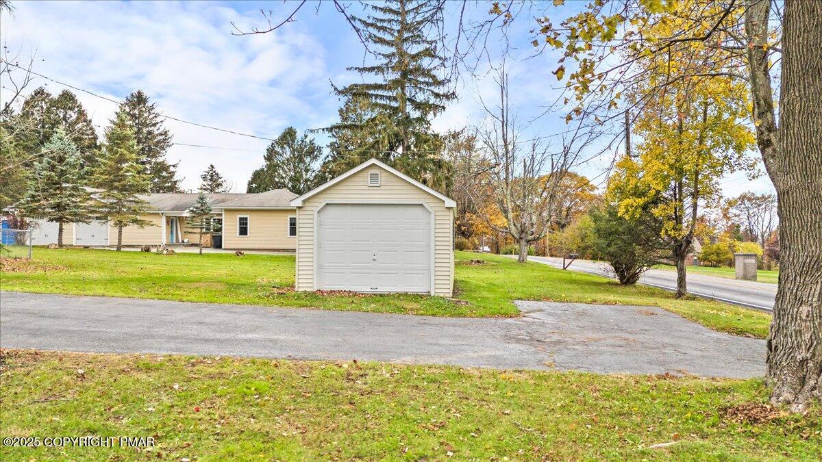 1215 Country Club Road Clarks Summit, PA 18411 - Photo 5 of 50 a front view of a house with a yard and garage