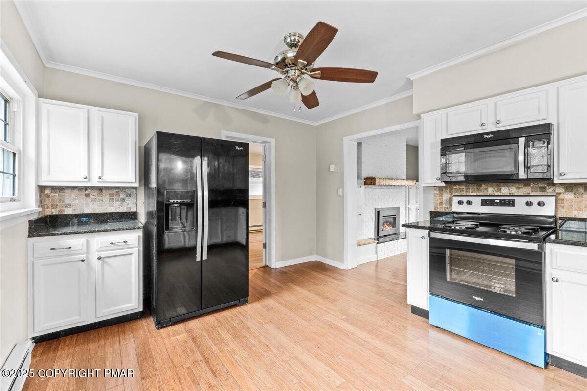 1215 Country Club Road Clarks Summit, PA 18411 - Photo 7 of 50 a kitchen with granite countertop a refrigerator a stove top oven a sink and dishwasher with wooden floor