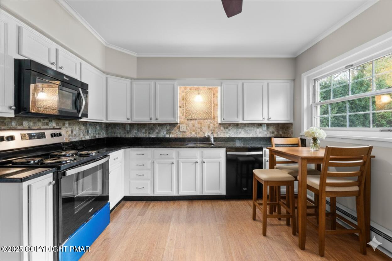 1215 Country Club Road Clarks Summit, PA 18411 - Photo 9 of 50 a kitchen with stainless steel appliances a stove a sink a microwave a refrigerator and cabinets