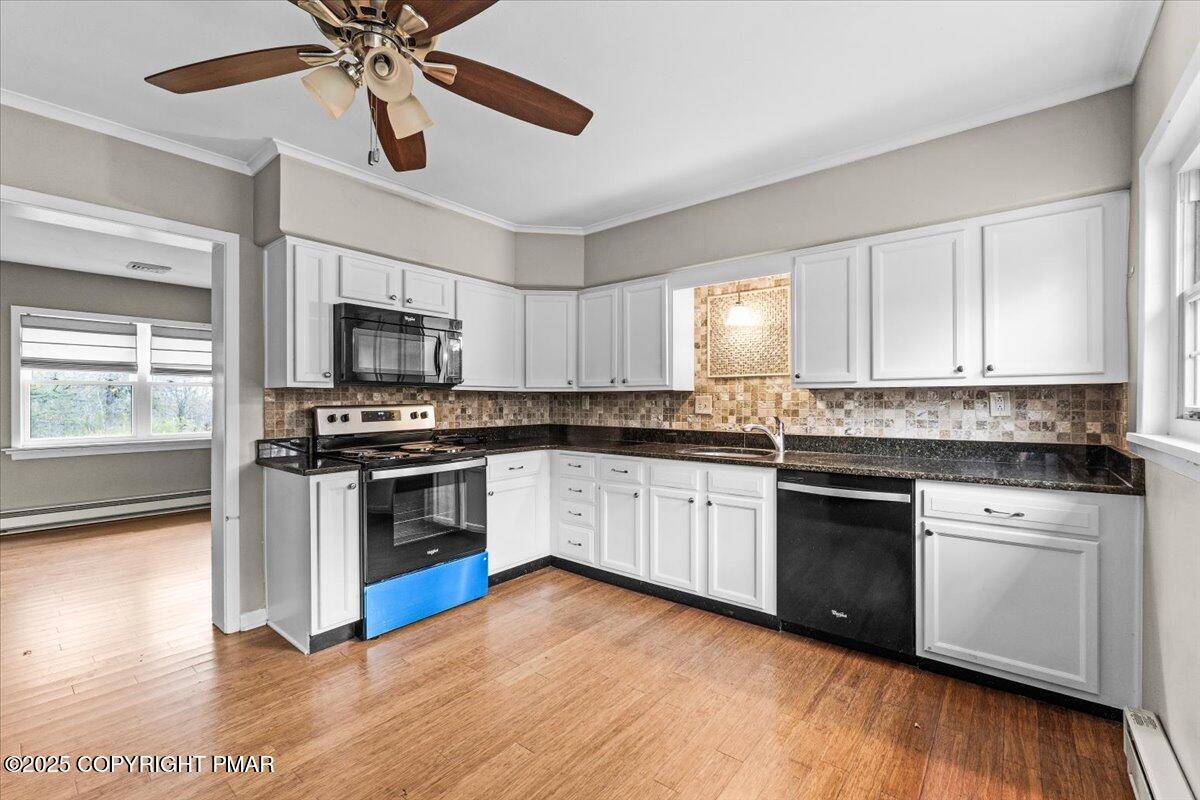 1215 Country Club Road Clarks Summit, PA 18411 - Photo 10 of 50 a kitchen with granite countertop a sink cabinets stainless steel appliances and a window