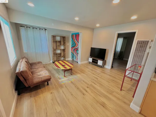 a backyard of a house with barbeque oven table and chairs