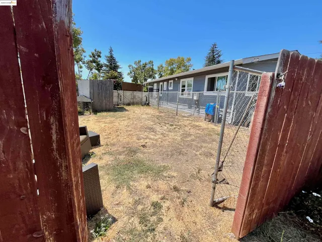 a view of a backyard with sitting area