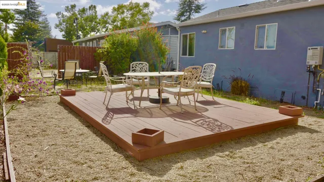a view of a backyard with sitting area