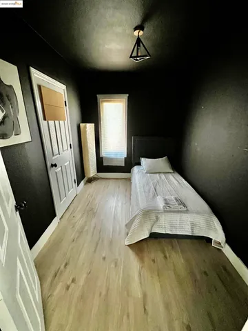 a bed sitting in a bedroom next to a window