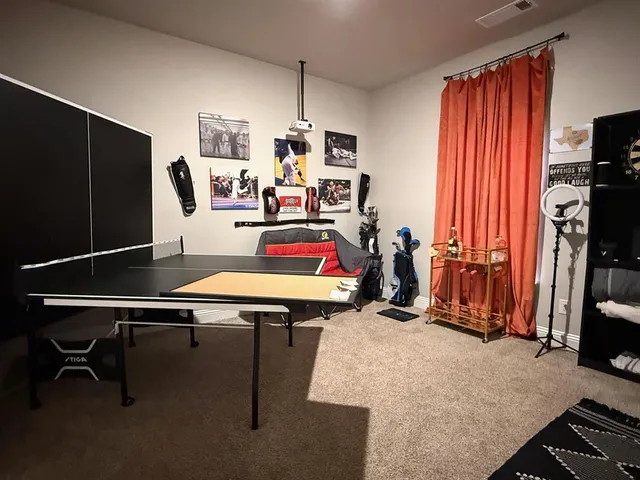 a room with furniture a flat screen tv and a window