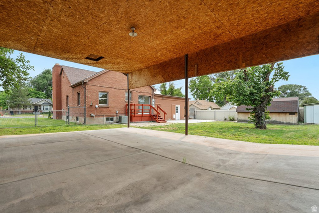 673 East 700 South Springville, UT 84663 - Photo 42 of 43 Spacious concrete patio and carport with wood-finish ceiling, offering coverage and exterior access
