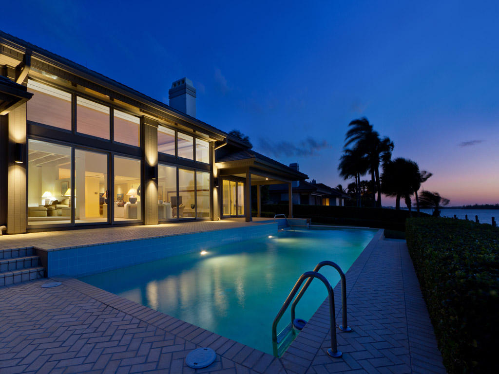 a view of a swimming pool with an outdoor seating