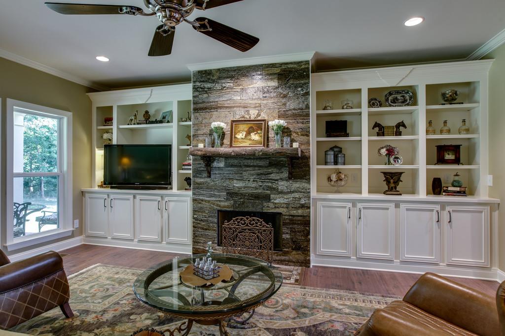 7901 Pinewood Road Fairview, TN 37062 - Photo 11 of 30 a living room with furniture a flat screen tv and a fireplace