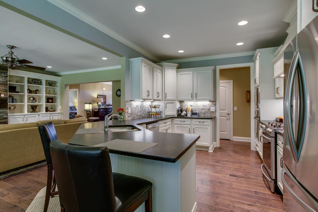 7901 Pinewood Road Fairview, TN 37062 - Photo 16 of 30 a kitchen with counter space dining table and stainless steel appliances