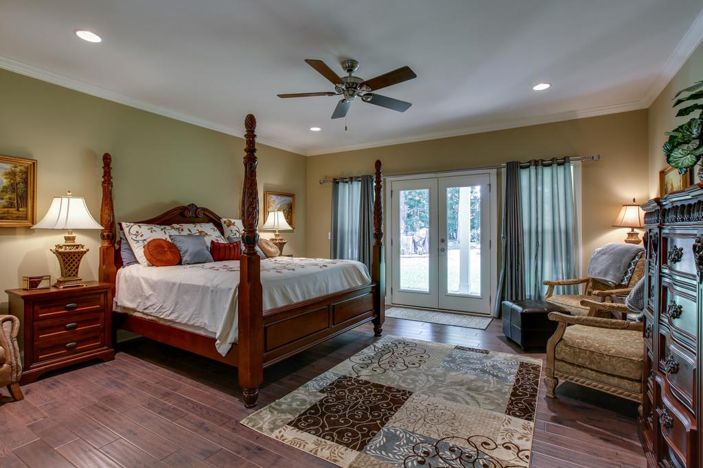 7901 Pinewood Road Fairview, TN 37062 - Photo 18 of 30 a bedroom with a bed and wooden floor