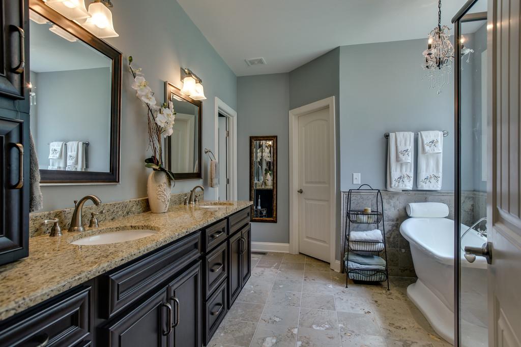 7901 Pinewood Road Fairview, TN 37062 - Photo 19 of 30 a spacious bathroom with a granite countertop sink and a mirror