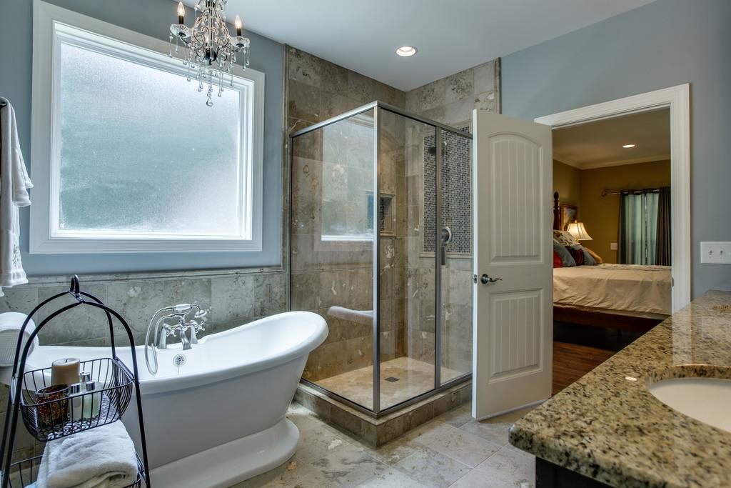 7901 Pinewood Road Fairview, TN 37062 - Photo 20 of 30 a bathroom with a tub and a mirror