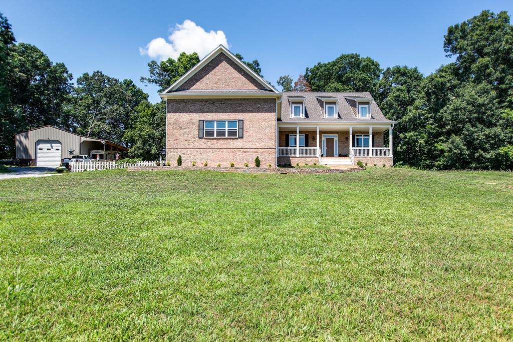 7901 Pinewood Road Fairview, TN 37062 - Photo 2 of 30 a front view of a house with a garden