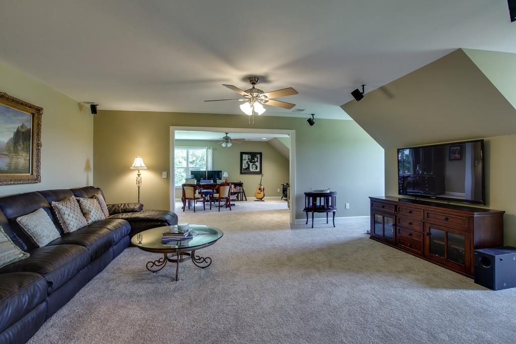 7901 Pinewood Road Fairview, TN 37062 - Photo 25 of 30 a living room with furniture and a flat screen tv