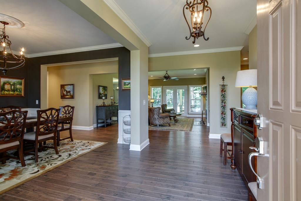 7901 Pinewood Road Fairview, TN 37062 - Photo 8 of 30 a view of a livingroom with furniture wooden floor and a chandelier