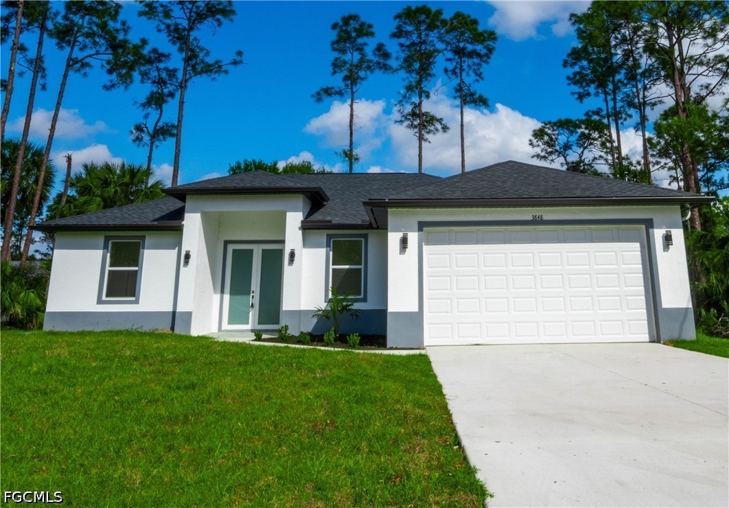 a front view of a house with a yard and garage