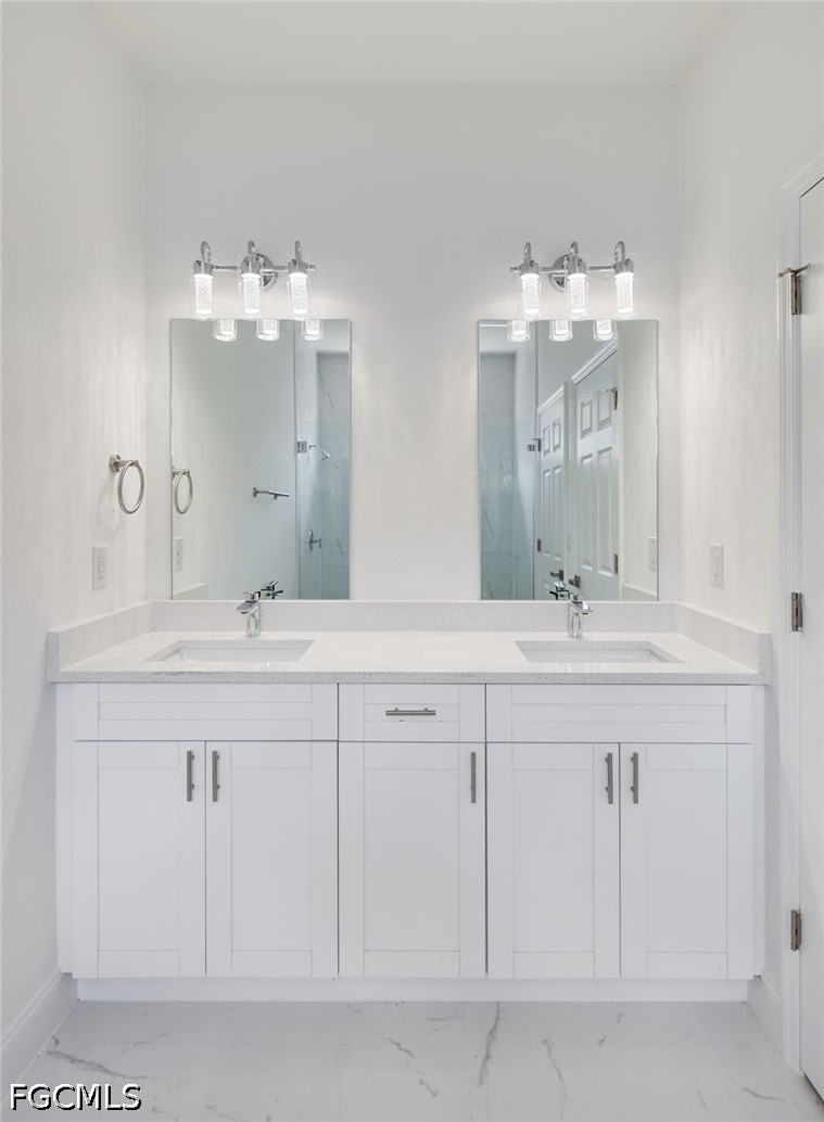 3000 3rd Street Southwest Lehigh Acres, FL 33976 - Photo 15 of 24 a bathroom with double sink and a mirror