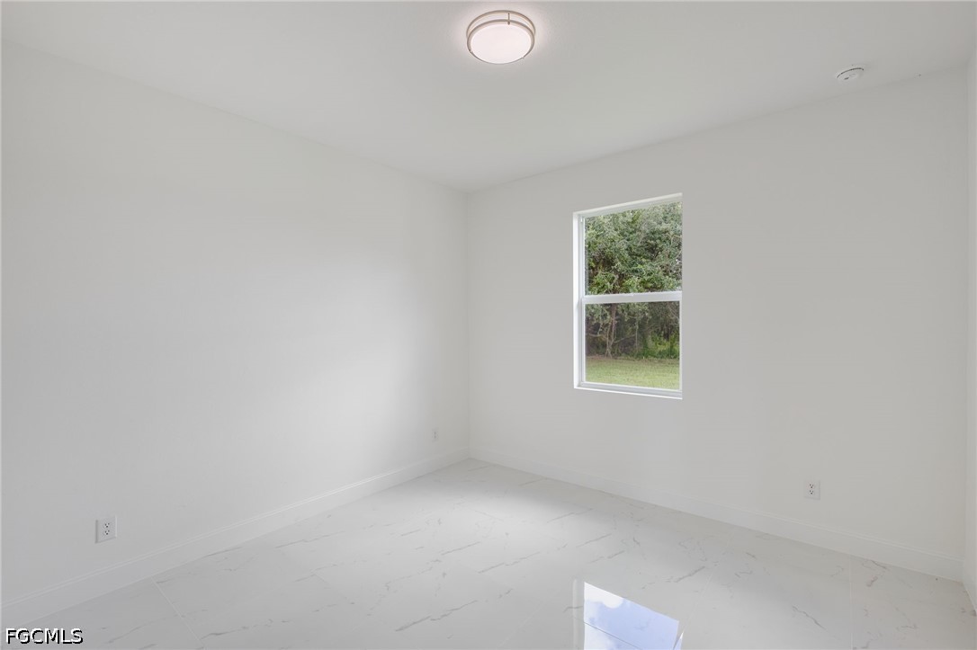 3000 3rd Street Southwest Lehigh Acres, FL 33976 - Photo 21 of 24 an empty room with a window