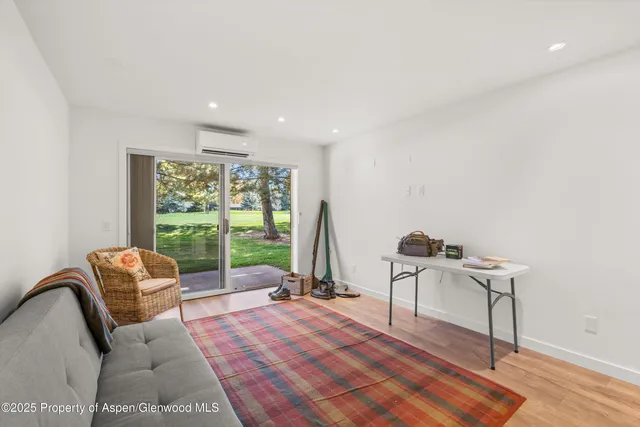 a living room with furniture and a floor to ceiling window