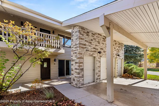a front view of a house with a tree