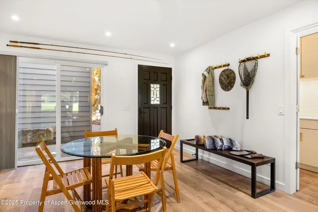 a dining room with furniture and wooden floor