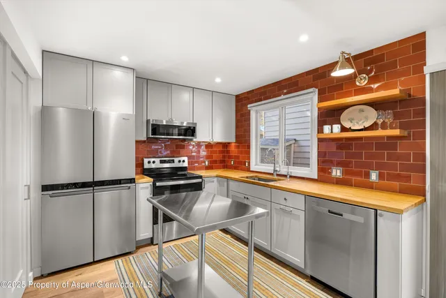 a kitchen with a refrigerator and a sink