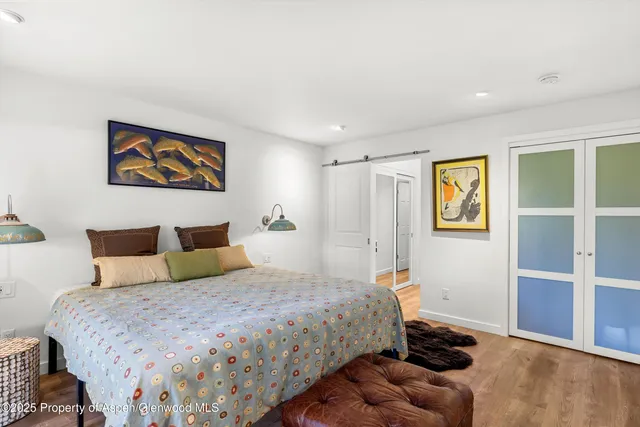 a bedroom with bed and cupboard