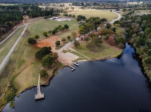 an aerial view of a house with a yard and lake view