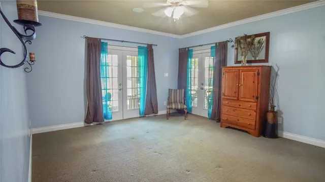 an empty room with windows closet and chandelier fan