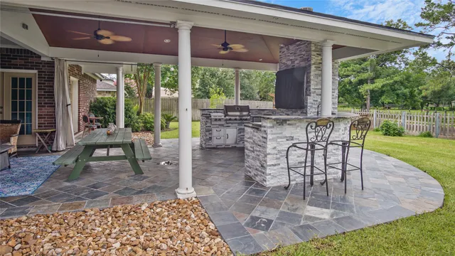 a view of a patio with a table chairs and a backyard
