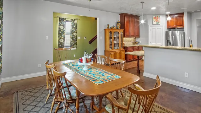 a view of a dining room with furniture and a window