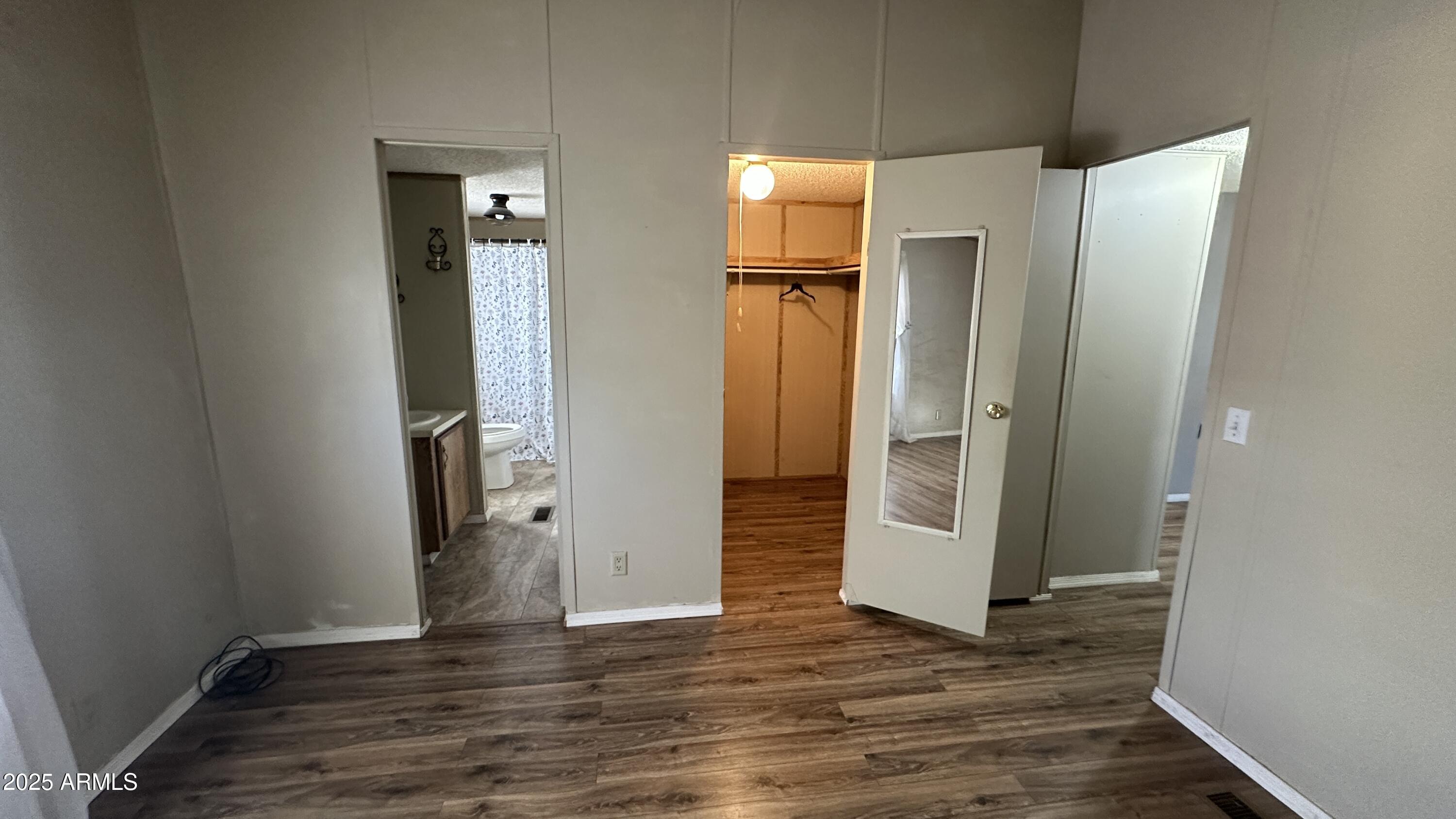 834 South Meridian Road, Unit 105 Apache Junction, AZ 85120 - Photo 13 of 48 an empty room with wooden floor and closet