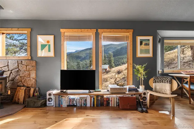 a living room with a large window and a table