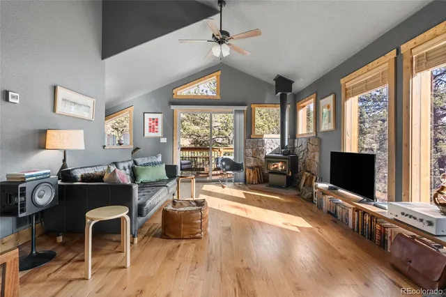 a living room with furniture flat screen tv and large windows