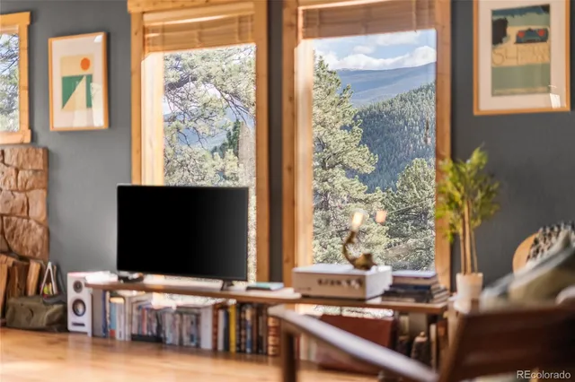 a living room with a large window and a flat screen tv