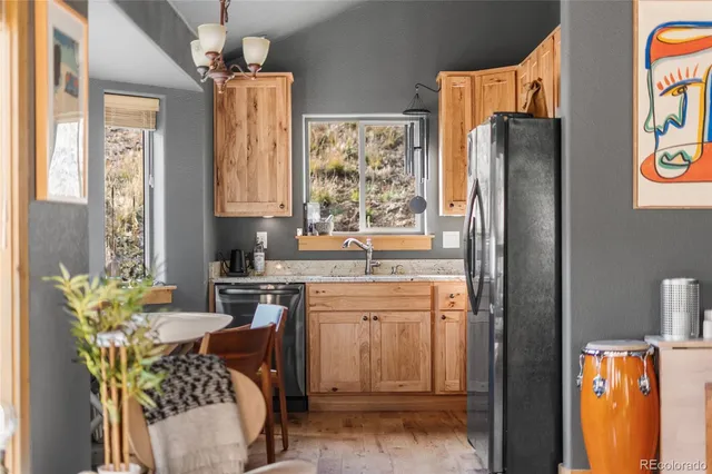 a kitchen with stainless steel appliances granite countertop a refrigerator and a stove