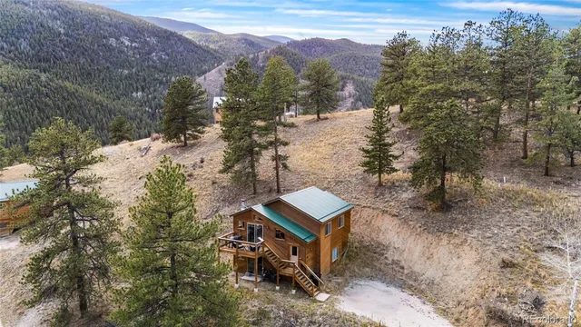 a view of a house with a yard and mountain
