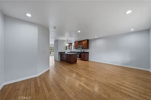 a kitchen with granite countertop a sink a counter space appliances and cabinets