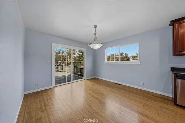 a view of kitchen and dining room with wooden floor
