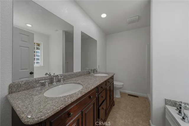 a white toilet sitting next to a shower