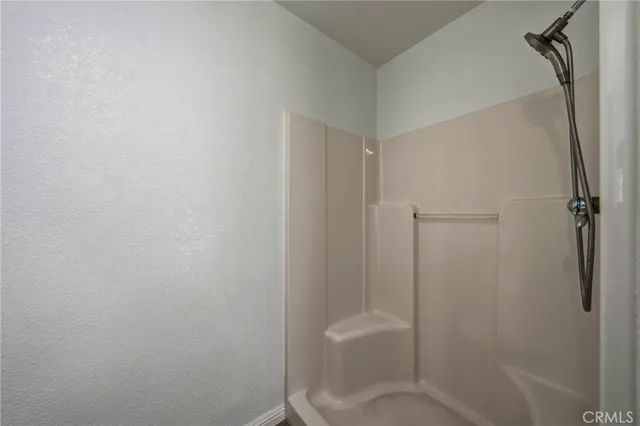 a view of a balcony with wooden floor and fence