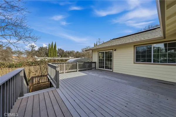 a aerial view of a house with a roof deck and chair