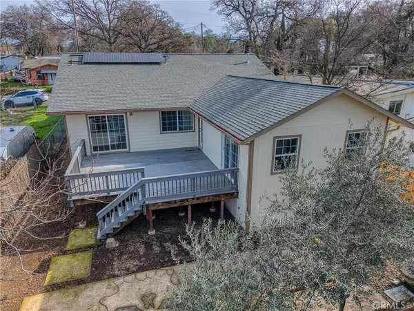 a view of a house with backyard and sitting area